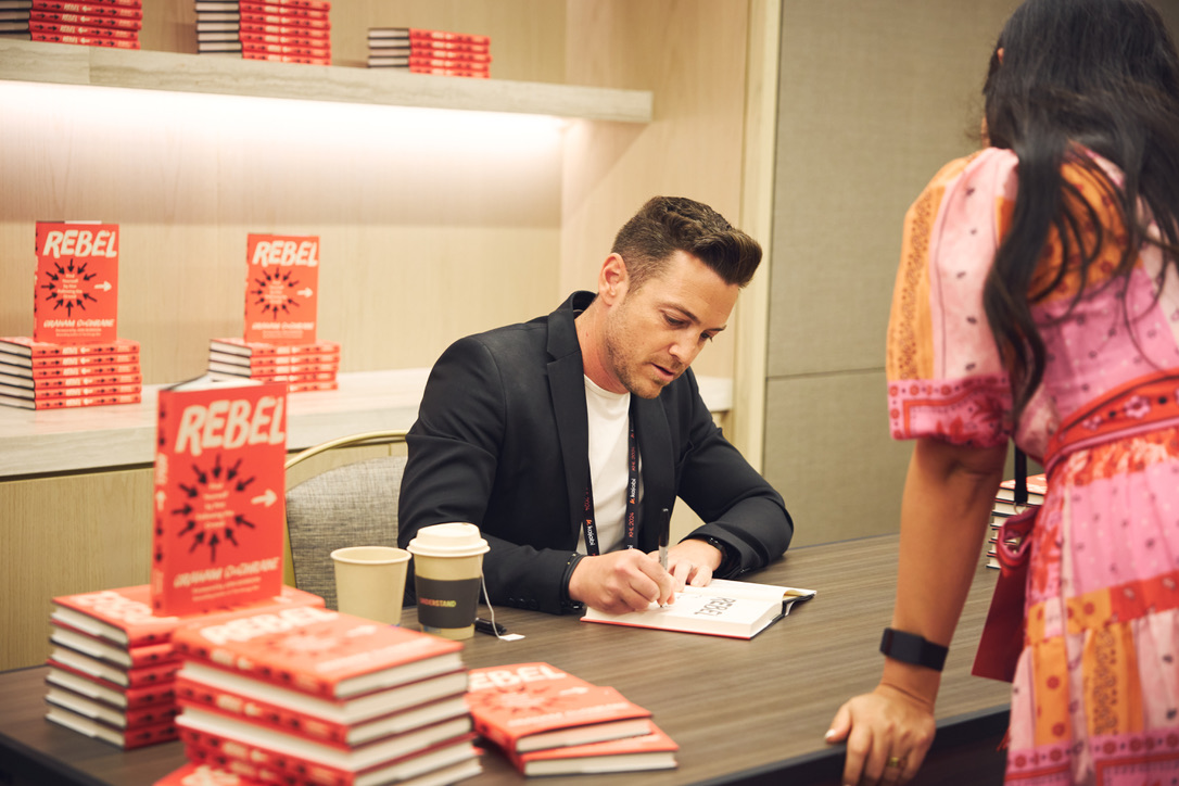 Graham Cochrane signing copies of Rebel at a book signing event